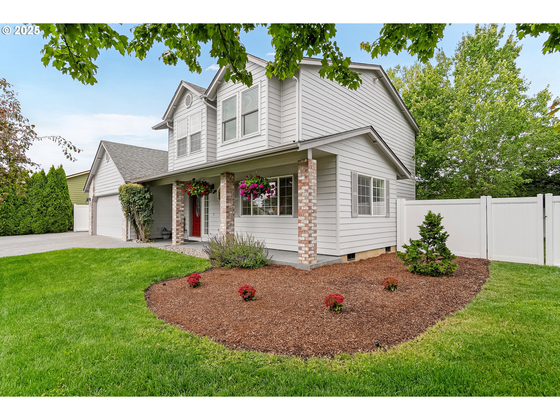 a aerial view of a house with a yard and potted plants