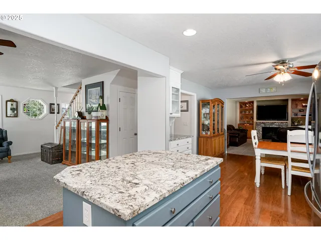 a living room with kitchen island dining table and wooden floor