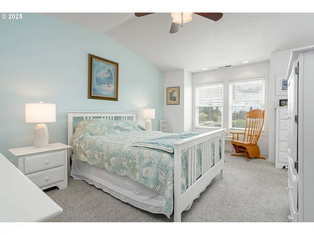 a bedroom with a bed a lamp and a window