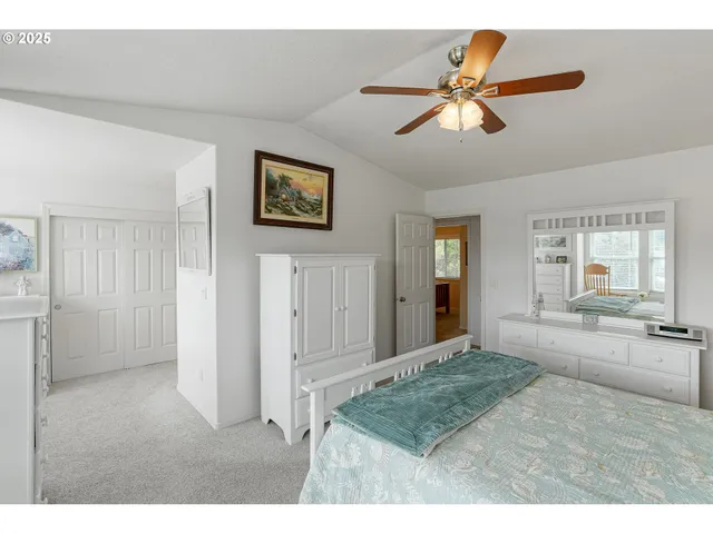 a view of a livingroom with a ceiling fan and window