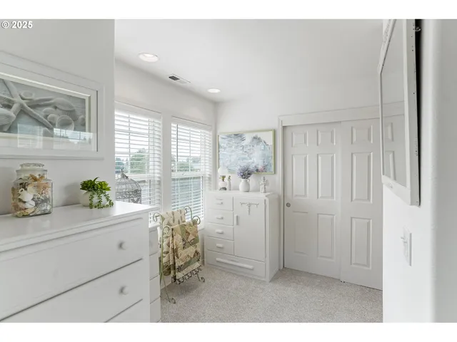 a kitchen with white cabinets and wooden floor