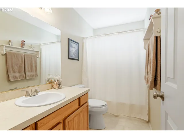 a bathroom with a sink toilet a mirror and shower