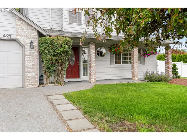a front view of a house with a garden