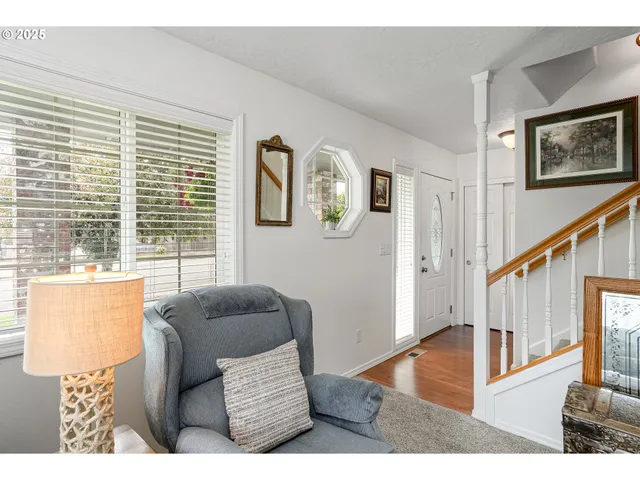 a living room with furniture and a floor to ceiling window