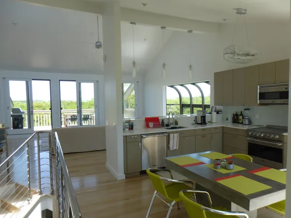 a kitchen with a table chairs stove and cabinets