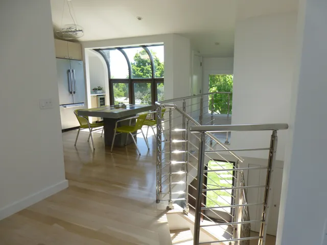 an outdoor view from a dining room with a large window