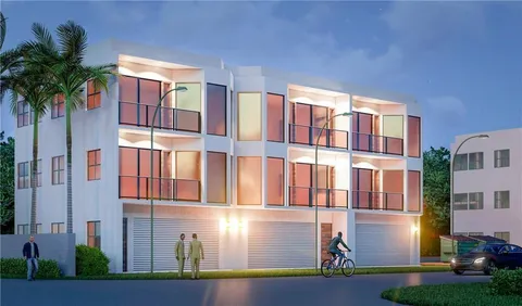 a front view of residential houses with yard