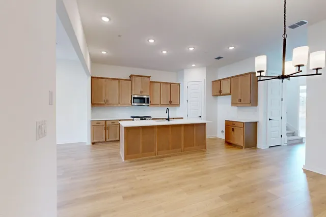 a view of an empty room with chandelier