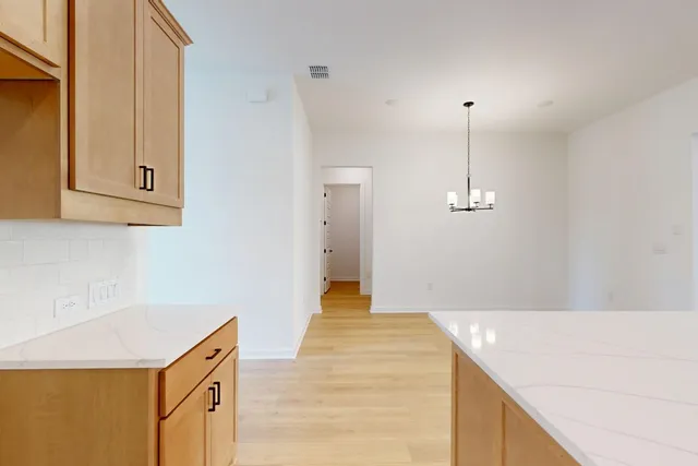 a kitchen with kitchen island stainless steel appliances a sink stove top oven and cabinets