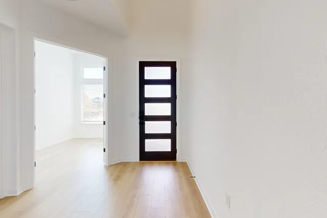 an empty room with windows and closet