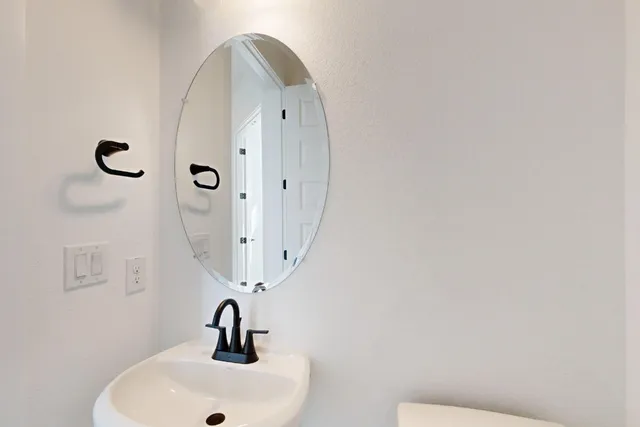 a bathroom with a sink and mirror