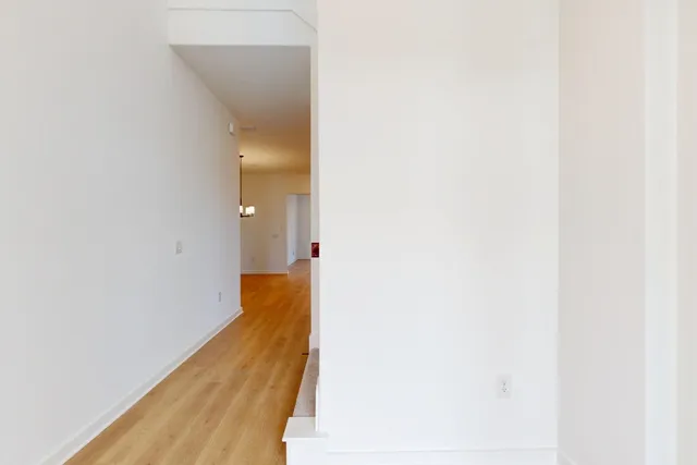 a view of a kitchen with a sink and dishwasher with wooden floor