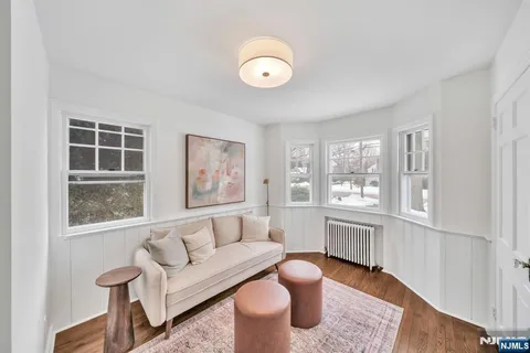 a bathroom with a toilet sink vanity granite and mirror