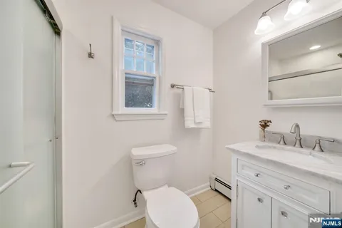 a view of a hallway with entryway and wooden floor