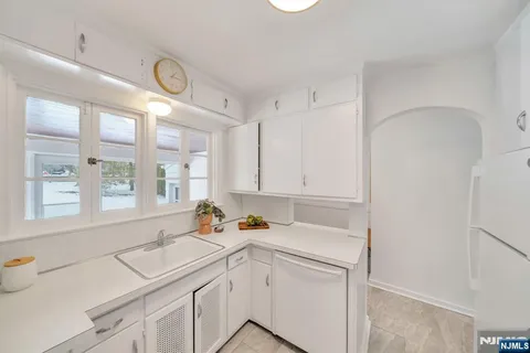 a kitchen with a sink stove and white cabinets
