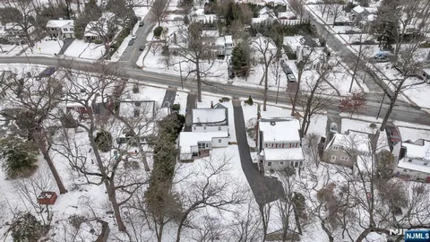a view of a house with a yard and potted plants