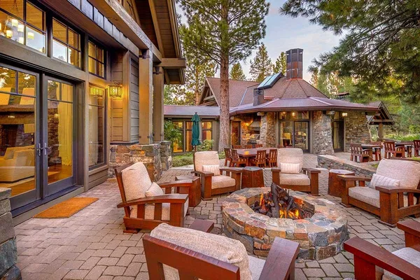 a view of a patio with couches table chairs and a fire pit