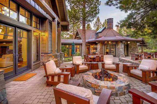 a view of a patio with couches table chairs and a fire pit