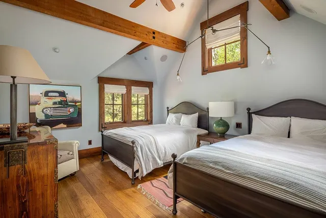 a bedroom with two beds and a window