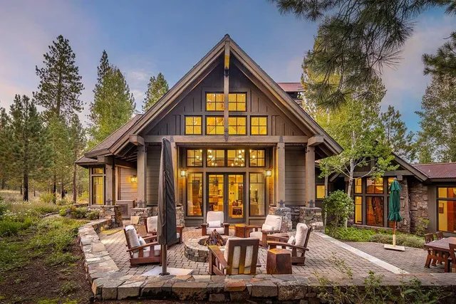 a view of a house with backyard porch and sitting area