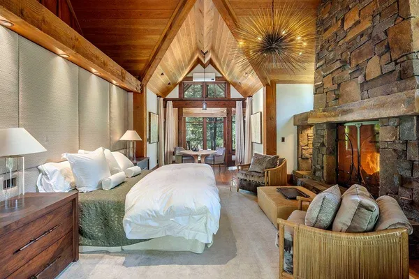 a bedroom with furniture and a large window