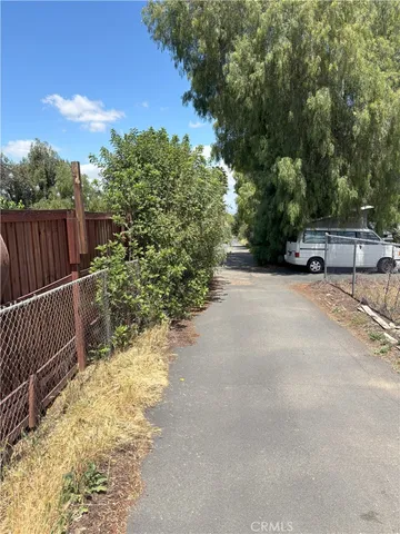 a view of a yard with wooden fence