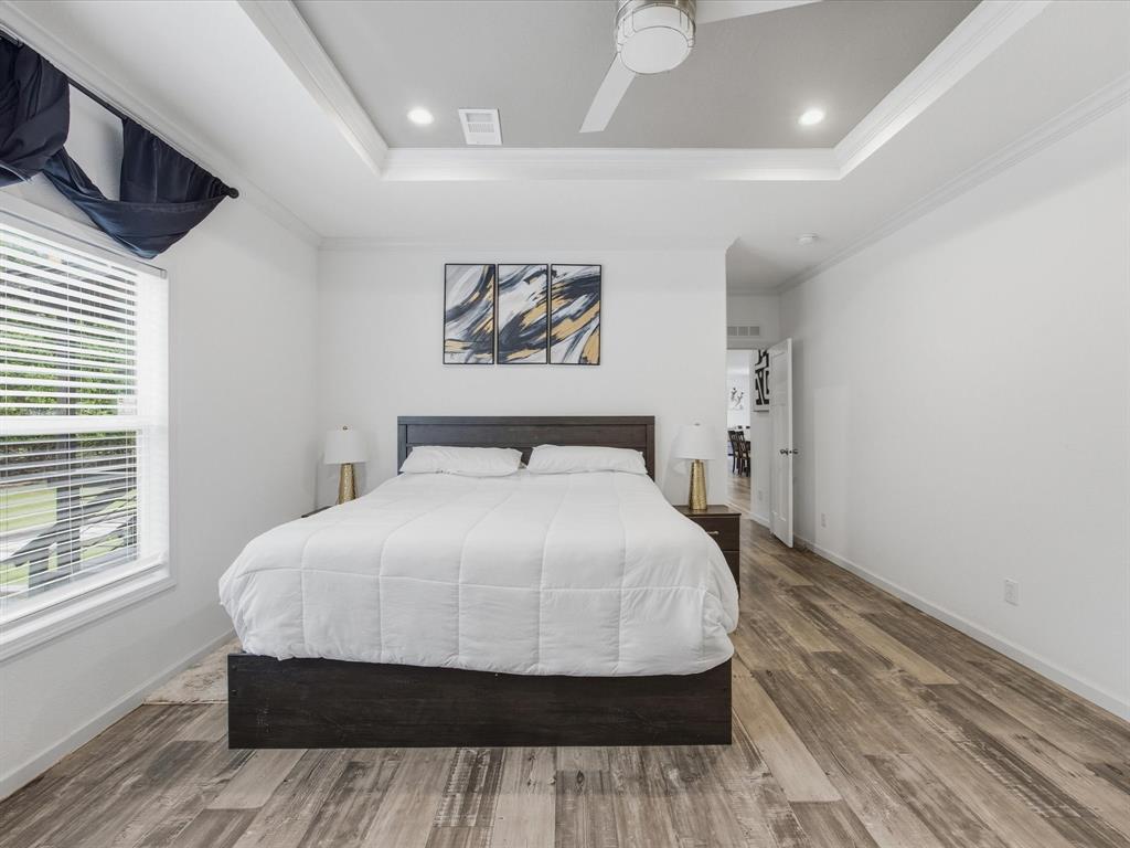 466 Belcher Road Bowie, TX 76230 - Photo 14 of 40 a bedroom with a bed and glass window