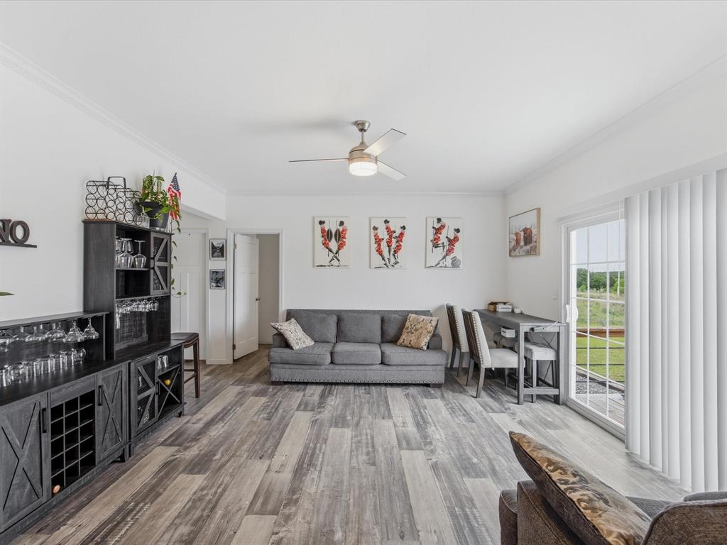 466 Belcher Road Bowie, TX 76230 - Photo 23 of 40 a living room with furniture and wooden floor