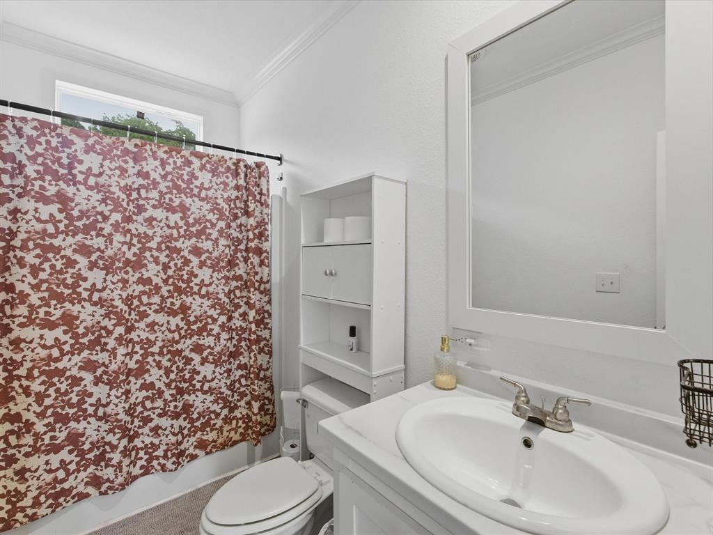 466 Belcher Road Bowie, TX 76230 - Photo 26 of 40 a bathroom with a sink toilet and shower