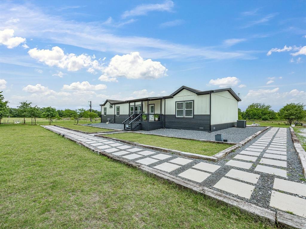 466 Belcher Road Bowie, TX 76230 - Photo 3 of 40 a view of house with swimming pool and yard