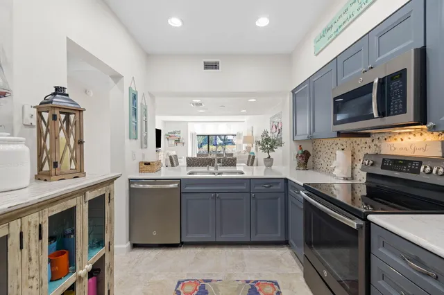 a kitchen with stainless steel appliances granite countertop a stove and a sink