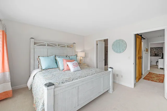 a bedroom with a bed and walk in closet