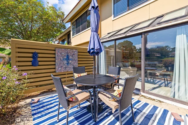 a view of a patio with a table and chairs
