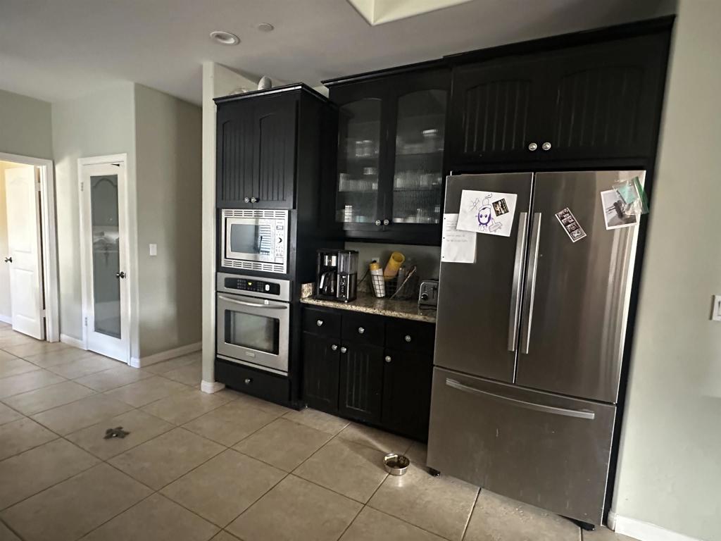 13907 Maxfield Road Jamul, CA 91935 - Photo 14 of 32 a kitchen with stainless steel appliances granite countertop a refrigerator and a stove