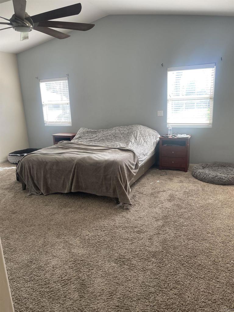 13907 Maxfield Road Jamul, CA 91935 - Photo 20 of 32 a bedroom with bed window and couch