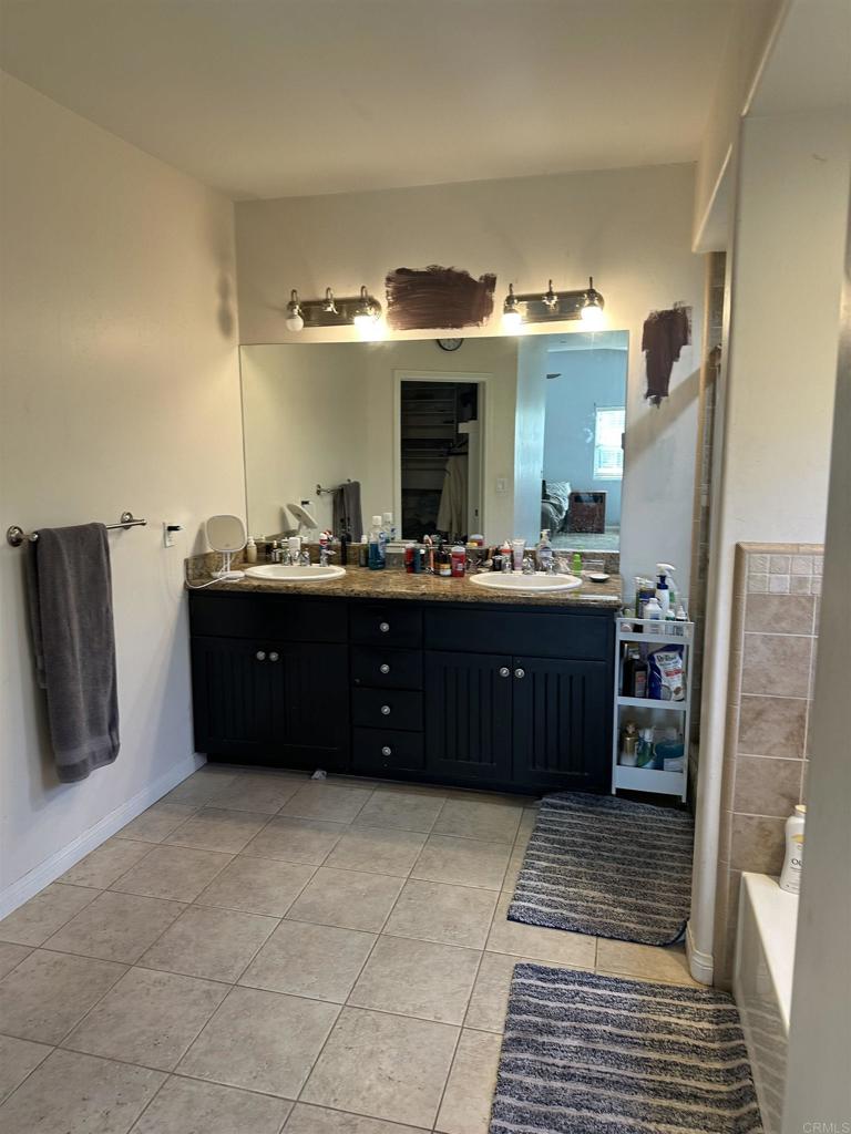 13907 Maxfield Road Jamul, CA 91935 - Photo 22 of 32 a bathroom with a granite countertop sink and a mirror