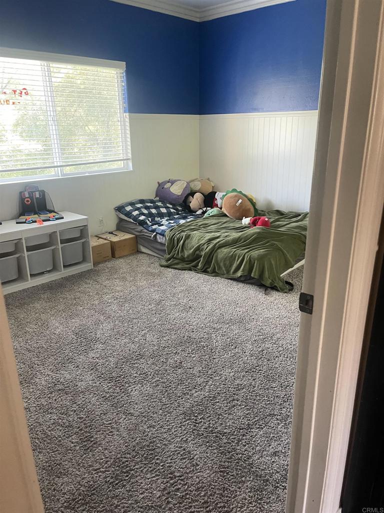 13907 Maxfield Road Jamul, CA 91935 - Photo 25 of 32 a bedroom with a bed and a window