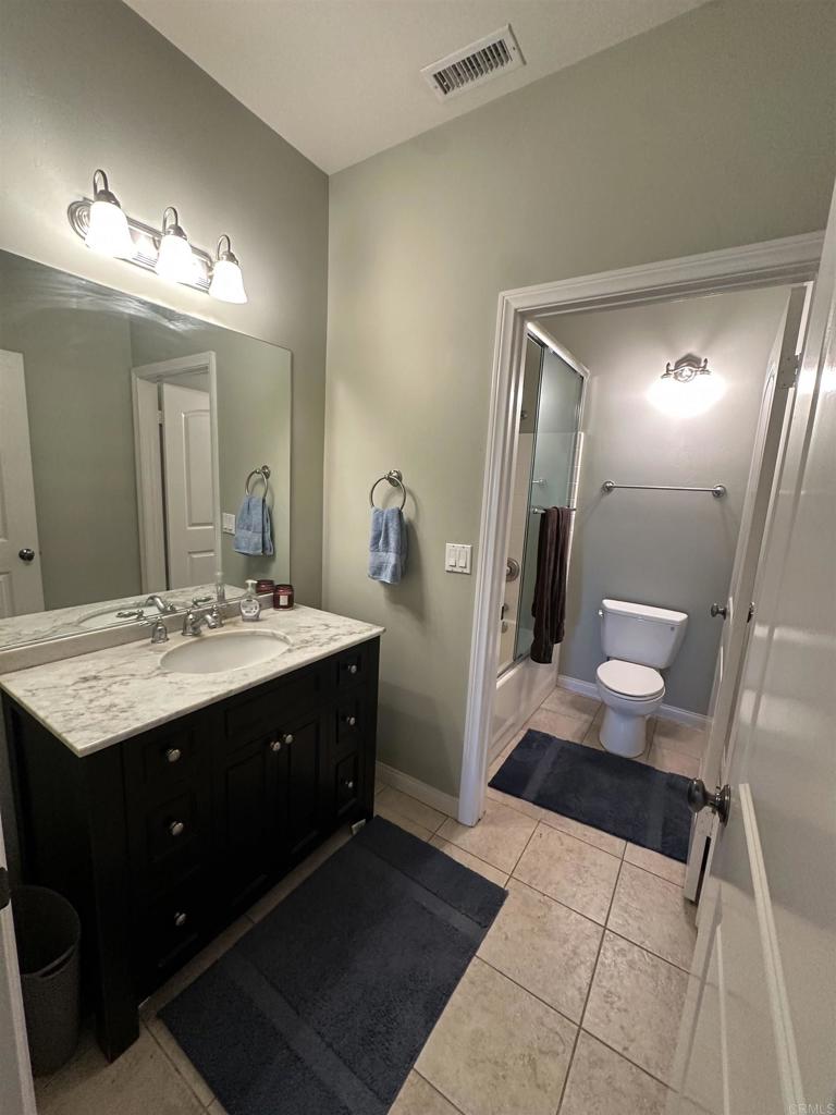 13907 Maxfield Road Jamul, CA 91935 - Photo 28 of 32 a bathroom with a sink and mirror