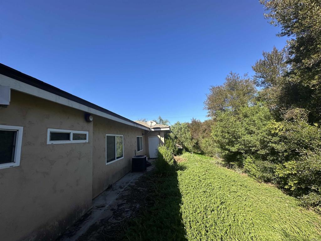 13907 Maxfield Road Jamul, CA 91935 - Photo 29 of 32 a back view of a house with a yard