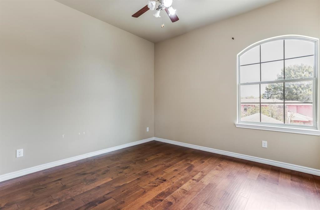 12364 Halima Street Dallas, TX 75243 - Photo 23 of 30 Wood-finish flooring, arched window, ceiling fan, and neutral wall tones