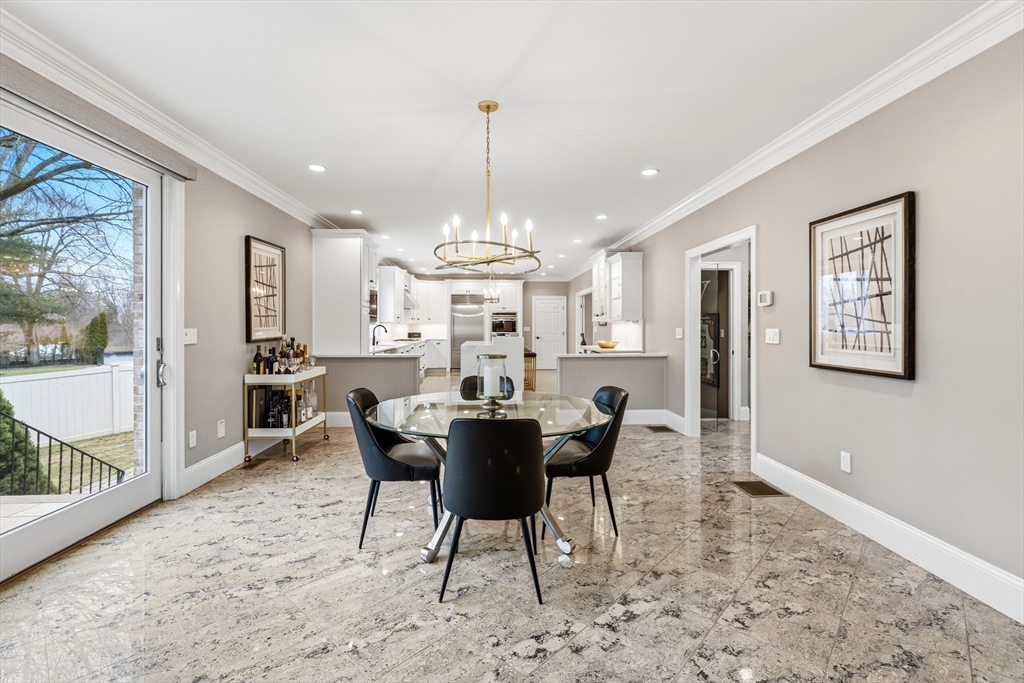 7 Freeman Street Lynnfield, MA 01940 - Photo 11 of 39 a dining room with furniture a chandelier and wooden floor
