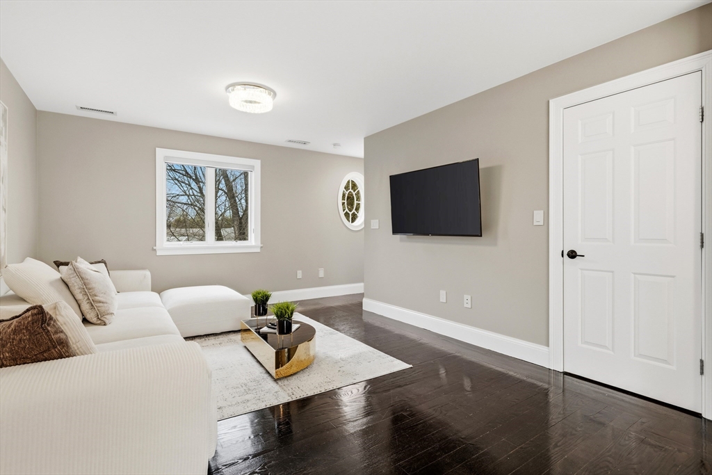 7 Freeman Street Lynnfield, MA 01940 - Photo 15 of 39 a living room with furniture and a flat screen tv