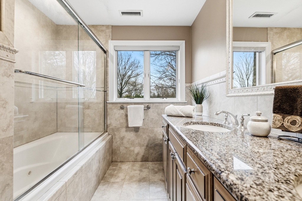 7 Freeman Street Lynnfield, MA 01940 - Photo 16 of 39 a bathroom with a granite countertop sink and a bathtub