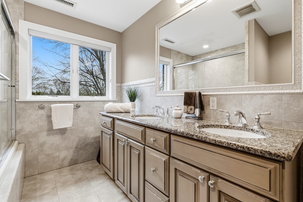 7 Freeman Street Lynnfield, MA 01940 - Photo 17 of 39 a bathroom with a granite countertop sink a mirror and a