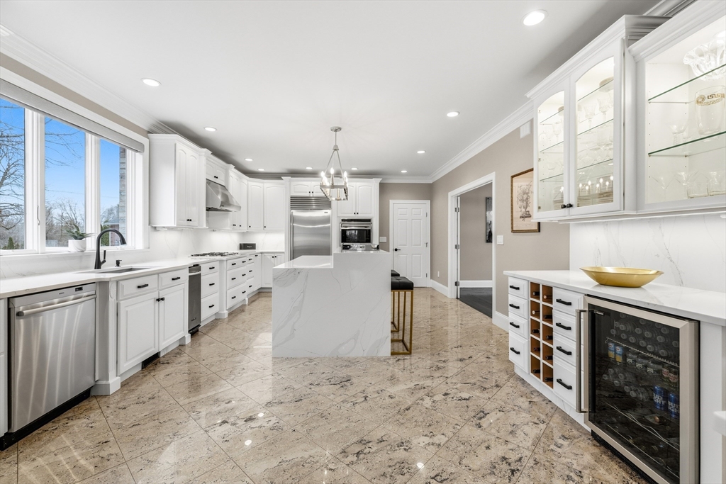7 Freeman Street Lynnfield, MA 01940 - Photo 8 of 39 a large kitchen with stainless steel appliances kitchen island granite countertop a large counter top and sink