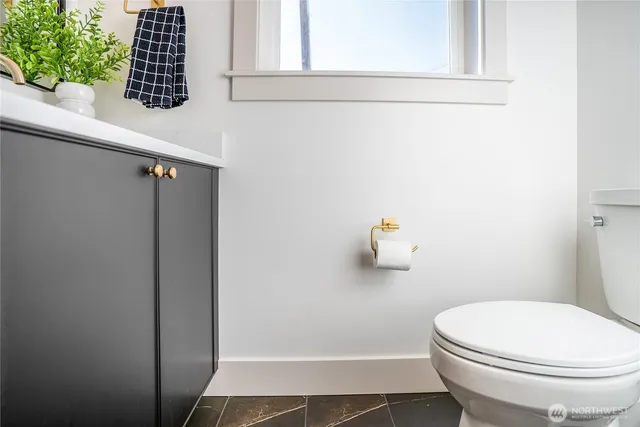 a spacious bedroom with a bed a couch and a window