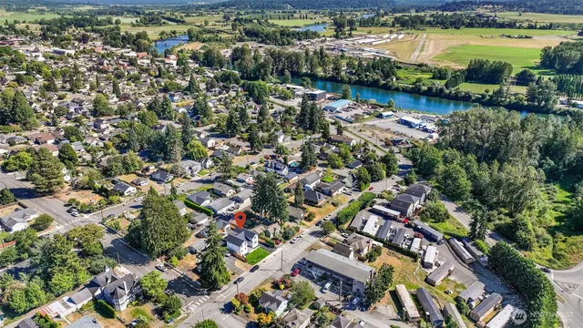 an aerial view of residential houses with outdoor space and lake view