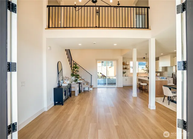 a view of a living room with furniture and wooden floor