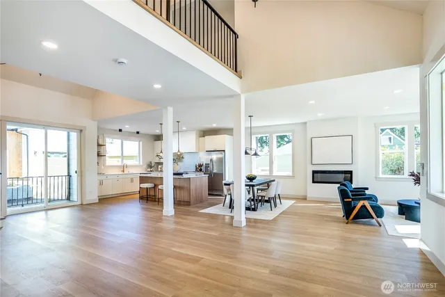 a living room with furniture wooden floor and a large window