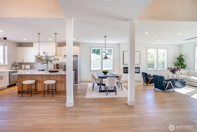 a view of a dining room with furniture wooden floor and windows